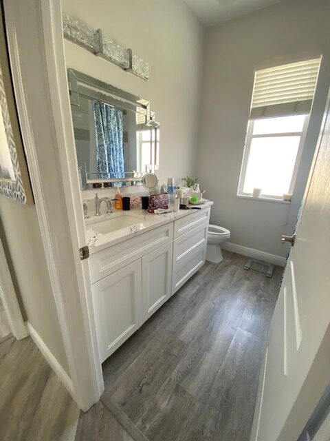 A Bathroom With White Color Counter and Cabinets